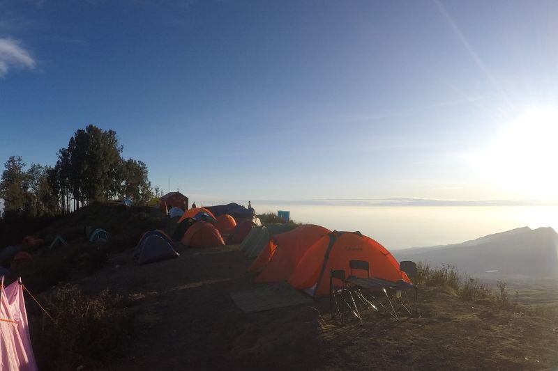Mount Rinjani crater rim campsite with sunrise view and tents above the clouds Lombok