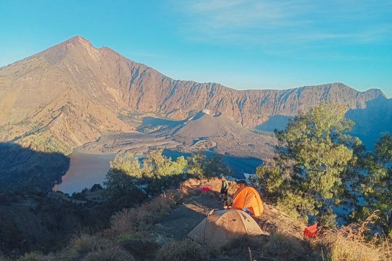 Mount Rinjani crater rim Senaru campsite with tents overlooking Segara Anak Lake Lombok