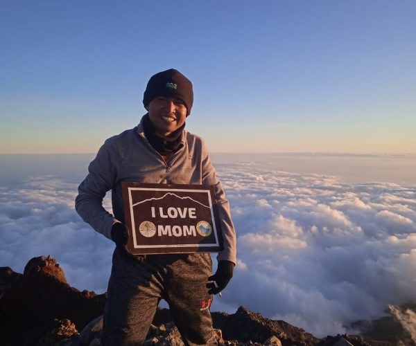 founder Rinjani Nomad at Mount Rinjani summit above clouds Lombok trekking guide